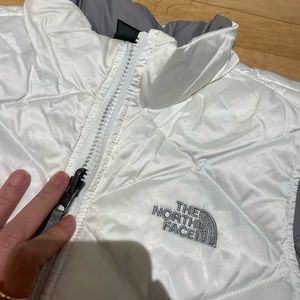The North Face EUC White 550 down fill puffer vest.